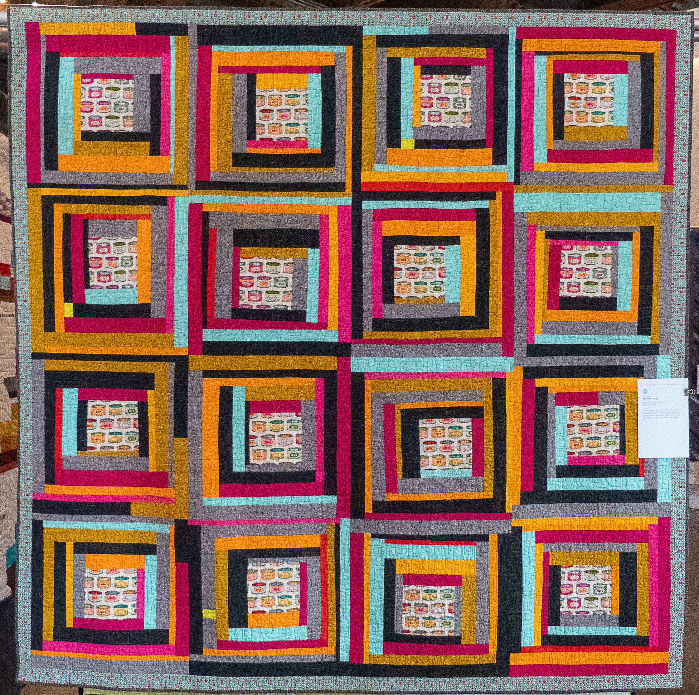 Modern quilt using the log cabin block design in bright colours