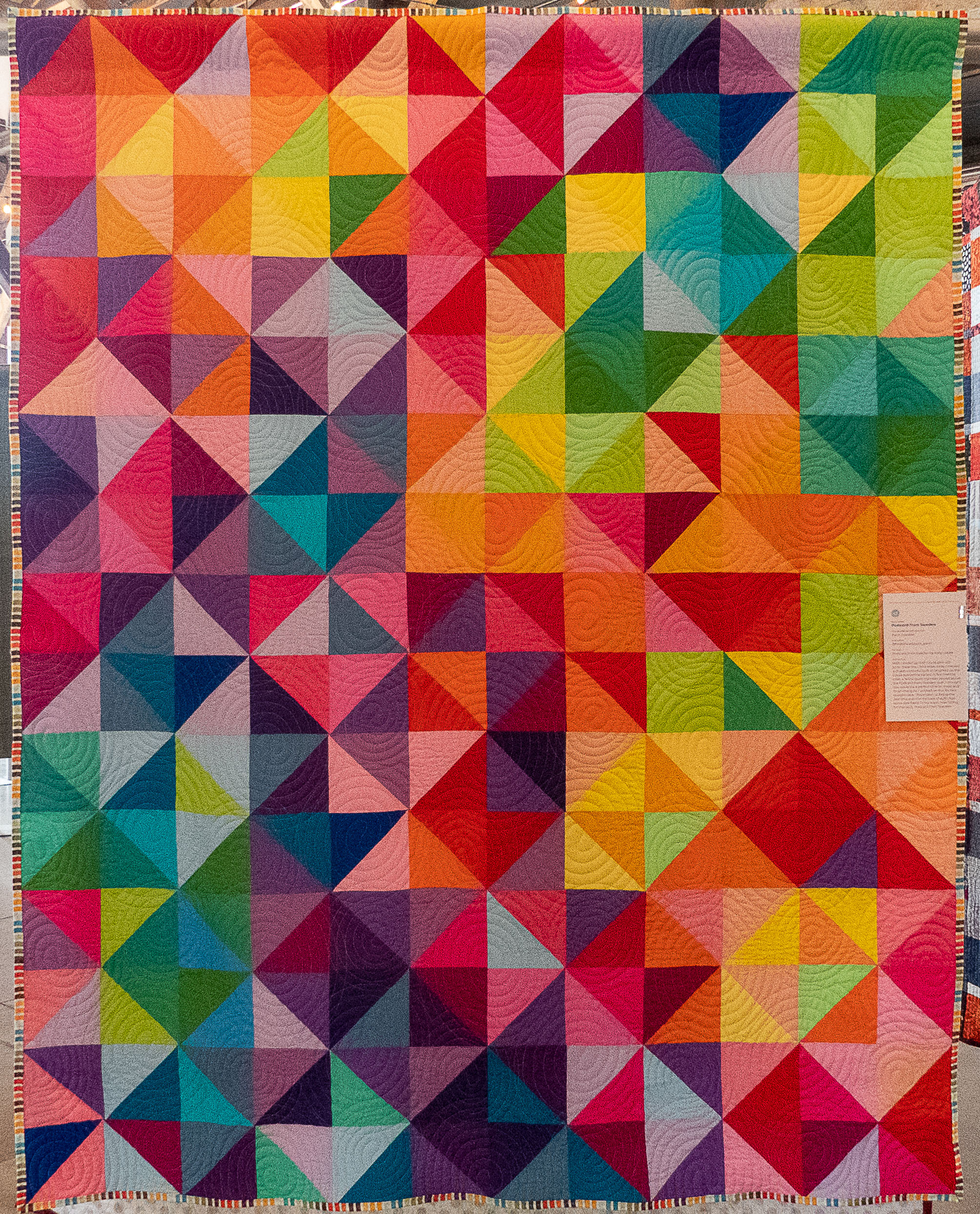 modern quilt of triangles in bright colours