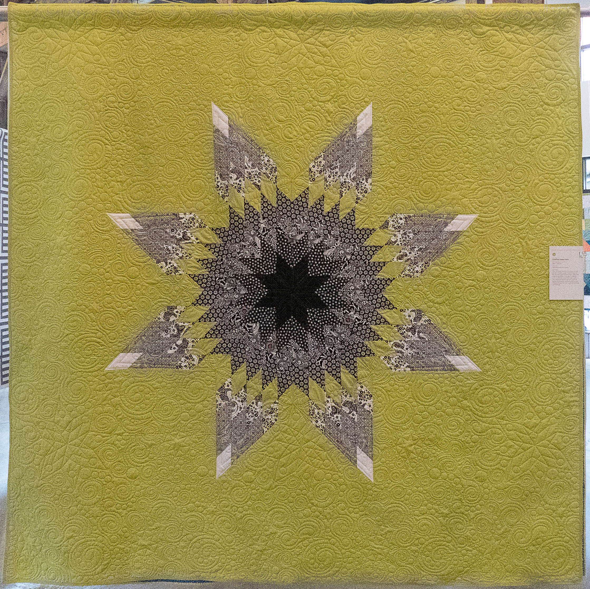 modern quilt containing a star in the middle