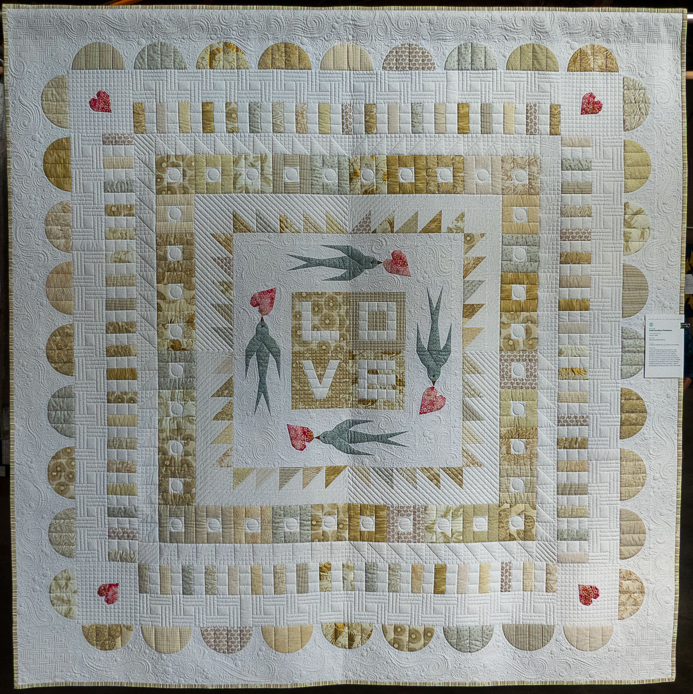 modern quilt with birds and the word LOVE in the middle