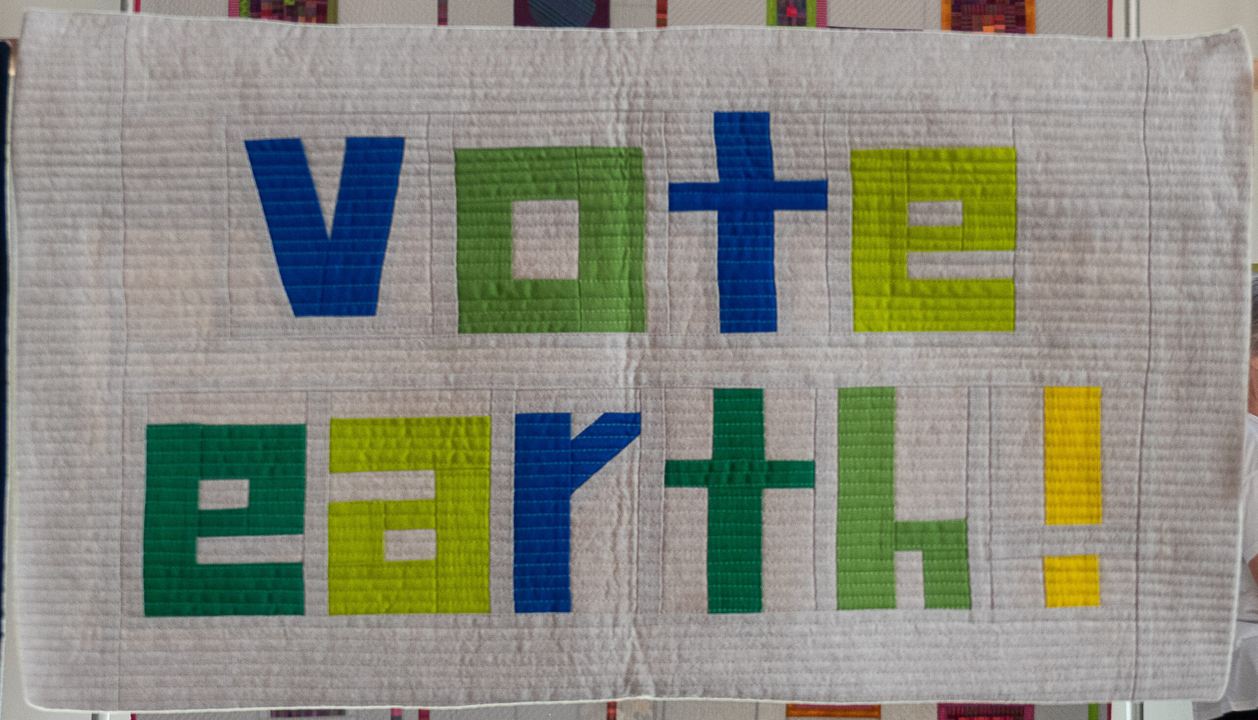modern quilt with the words "vote earth"